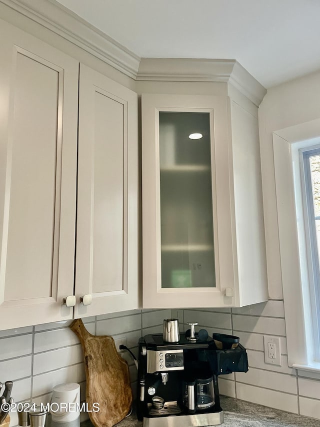 details with white cabinetry and backsplash