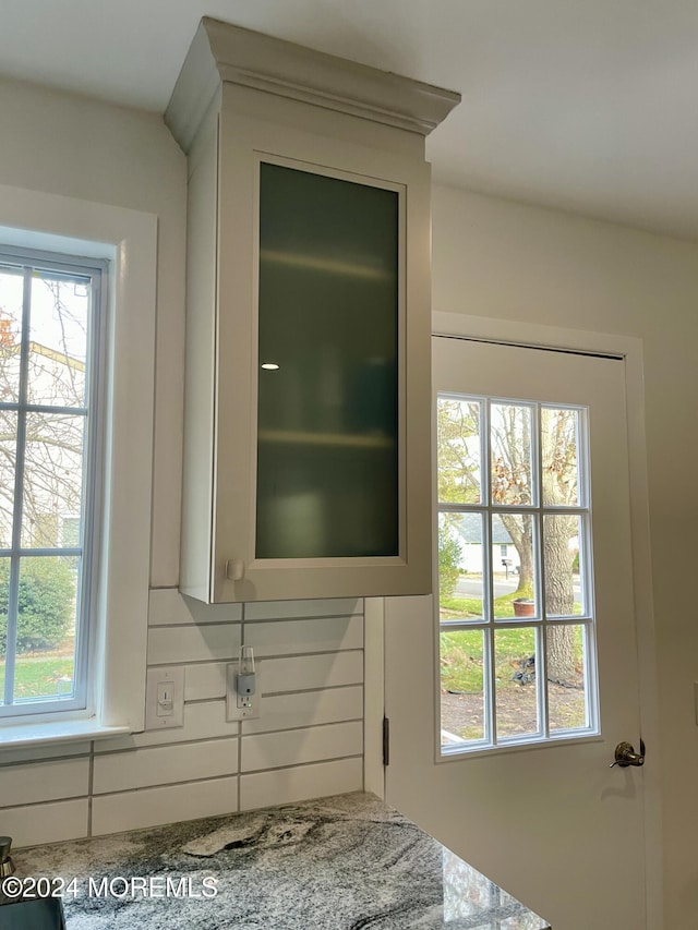 room details with backsplash and light stone countertops