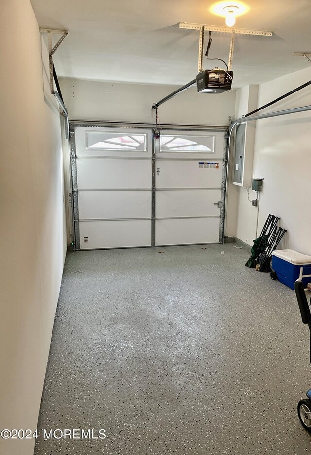 garage with electric panel and a garage door opener