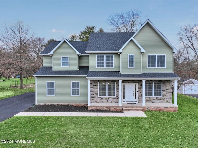 front of property featuring a porch and a front yard