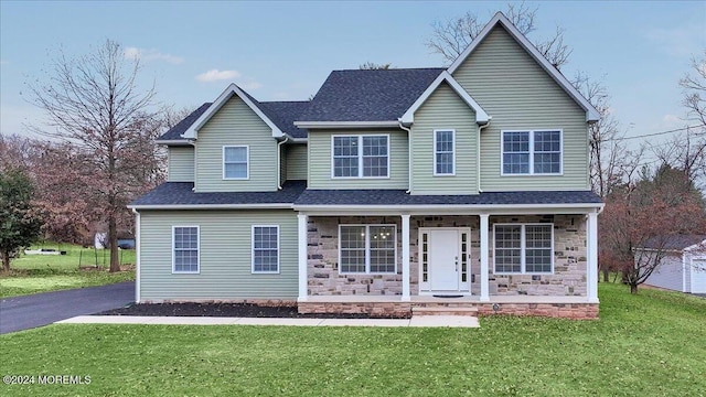 view of property featuring a front yard and a porch