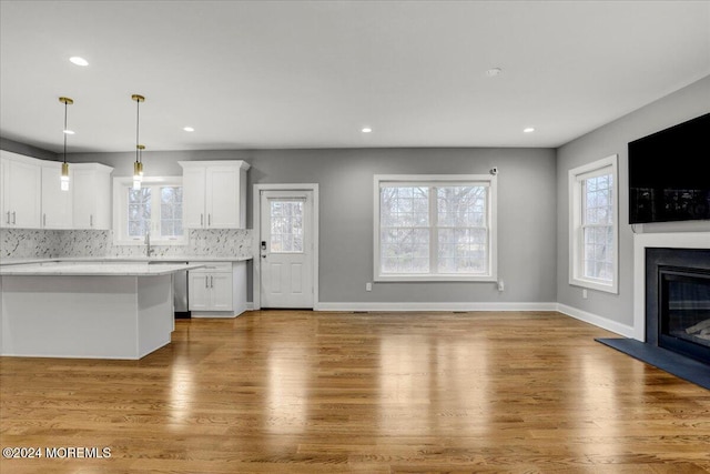 unfurnished living room with hardwood / wood-style floors and sink