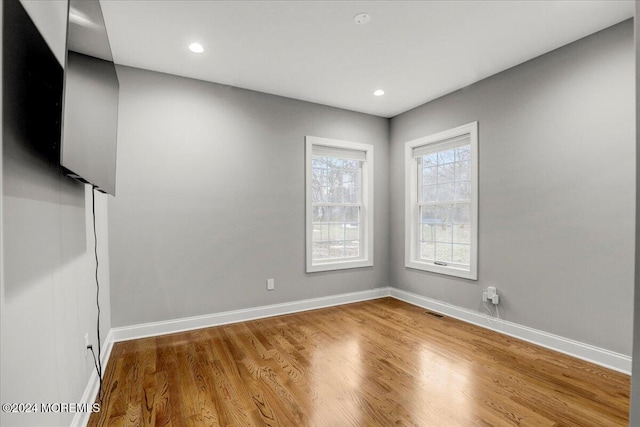 spare room with hardwood / wood-style flooring