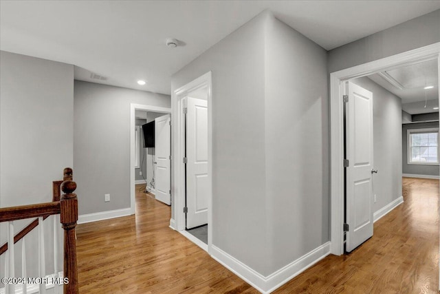 corridor with light wood-type flooring