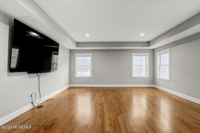 unfurnished living room with hardwood / wood-style flooring and a healthy amount of sunlight