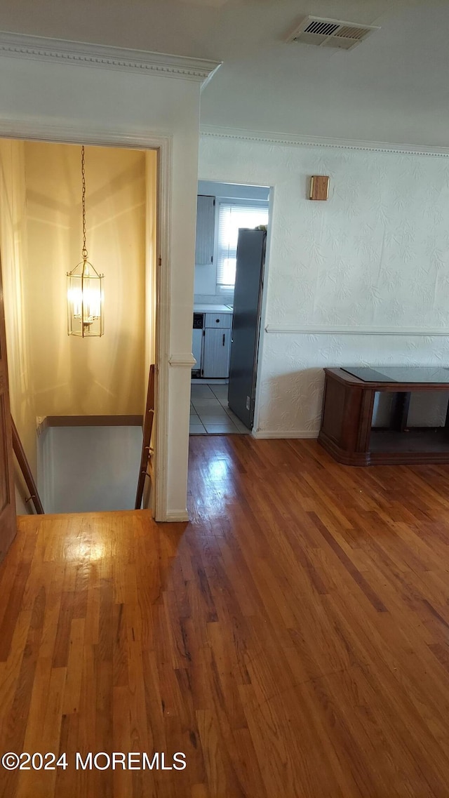 corridor featuring a chandelier and hardwood / wood-style floors