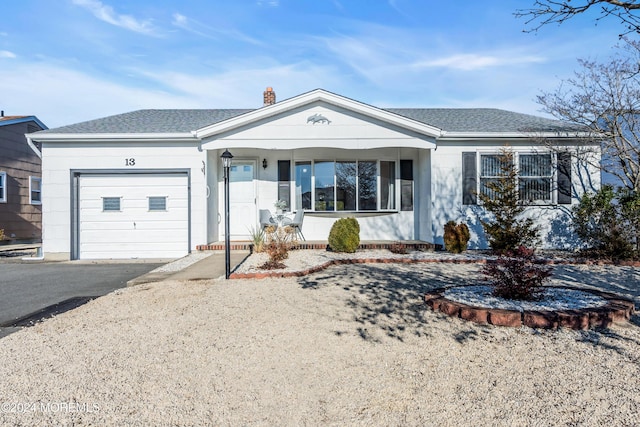 single story home with a porch and a garage