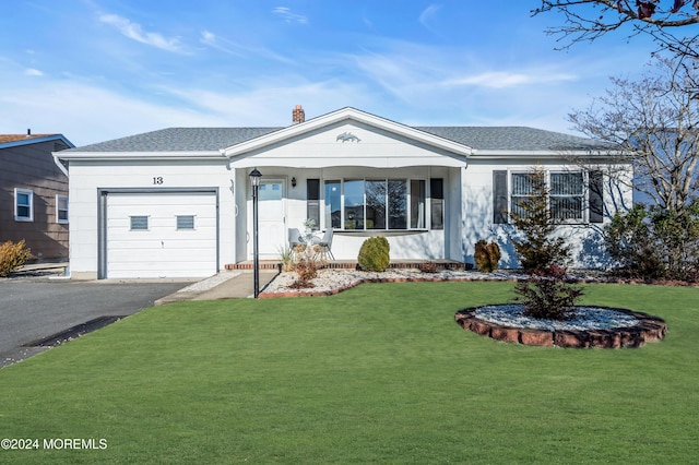 ranch-style home featuring a garage and a front yard