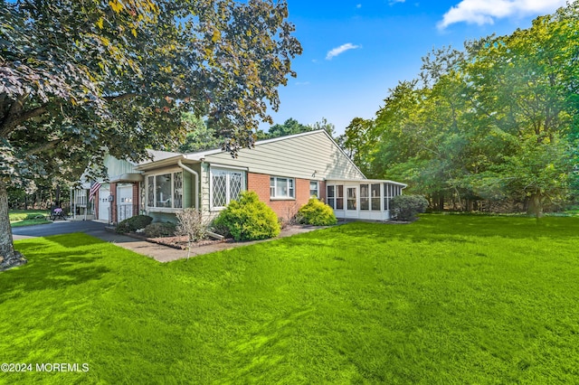 1 Dixon Ct Unit B, Whiting, NJ 08759 - back of property featuring a sunroom, a garage, a yard, driveway, and brick siding