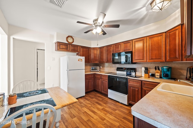 1 Dixon Ct Unit B, Whiting, NJ 08759 - kitchen with freestanding refrigerator, range with electric stovetop, black microwave, ceiling fan, and light countertops