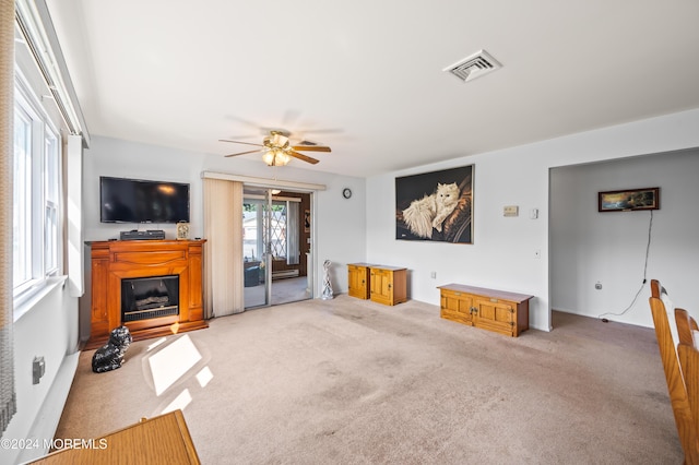 1 Dixon Ct Unit B, Whiting, NJ 08759 - unfurnished living room with carpet floors, a glass covered fireplace, and a ceiling fan
