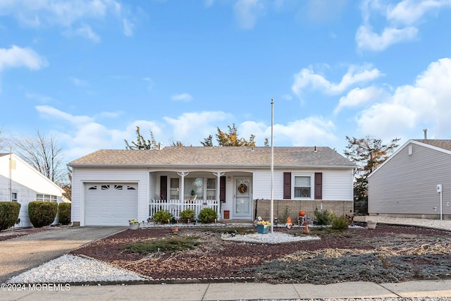 single story home featuring covered porch and a garage