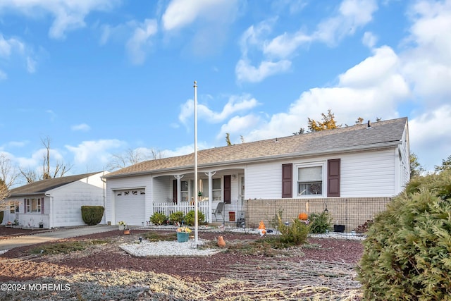 ranch-style home with covered porch and a garage