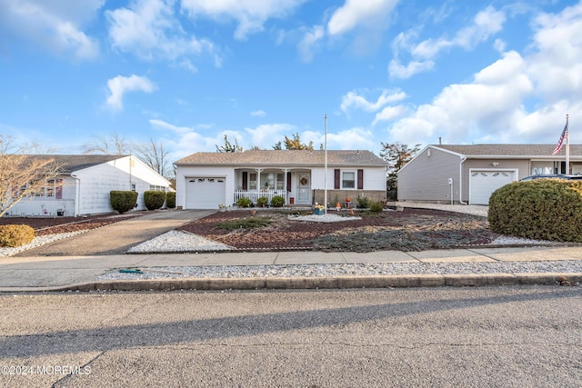 ranch-style home with covered porch and a garage