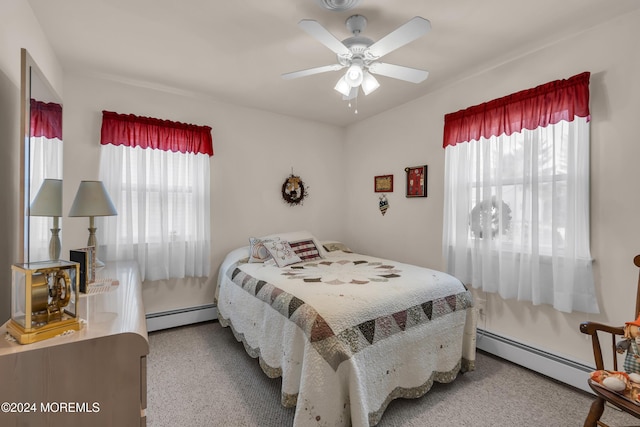 carpeted bedroom with ceiling fan and a baseboard heating unit