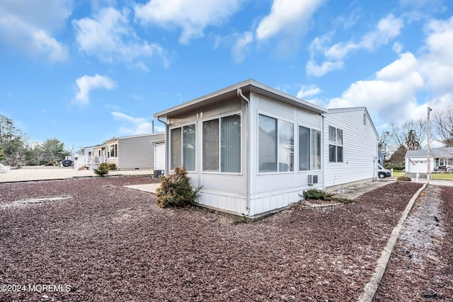 view of side of home featuring a sunroom