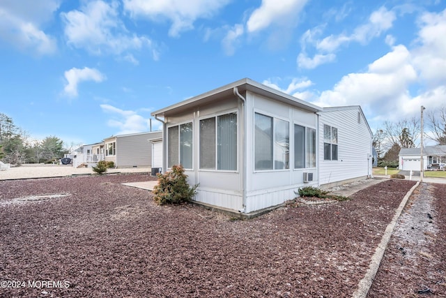 view of side of home with a sunroom