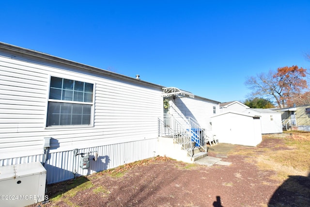 view of side of property featuring a storage unit