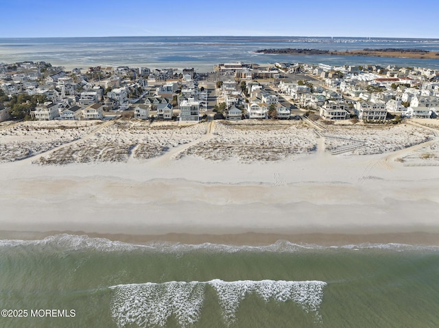 aerial view featuring a view of the beach and a water view