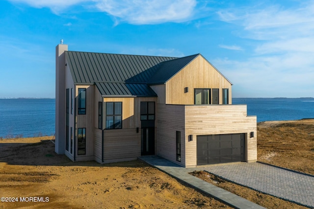 view of front of house featuring a water view and a garage