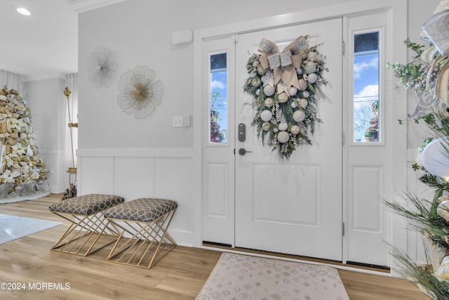 foyer featuring hardwood / wood-style flooring and crown molding