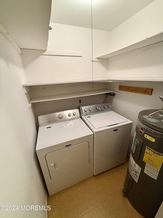 laundry room featuring washing machine and dryer and electric water heater