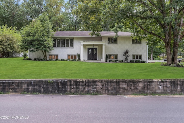 bi-level home with a front lawn