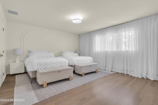 bedroom with wood-type flooring