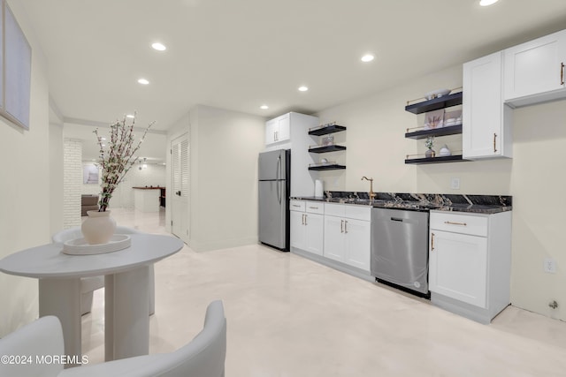 kitchen with white cabinets, dark stone countertops, sink, and appliances with stainless steel finishes