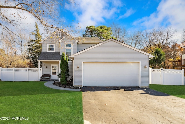 view of property featuring a front yard and a garage