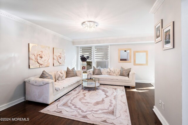 living room with a notable chandelier, dark hardwood / wood-style flooring, and crown molding