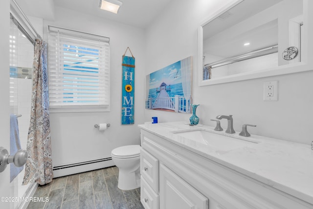 bathroom with toilet, a baseboard radiator, a shower with shower curtain, and vanity