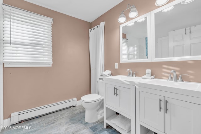 bathroom with toilet, vanity, and a baseboard heating unit