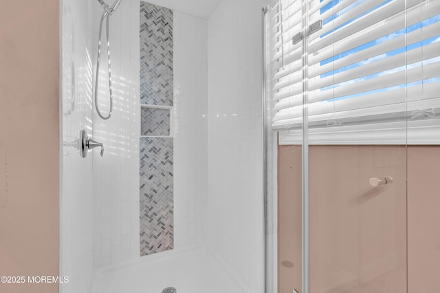 bathroom featuring a shower with door