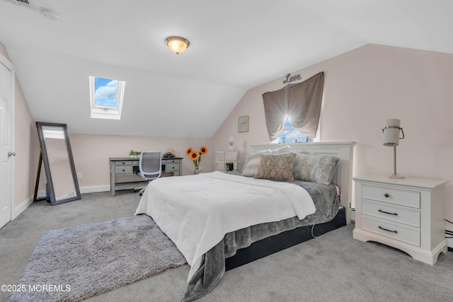 carpeted bedroom with lofted ceiling with skylight