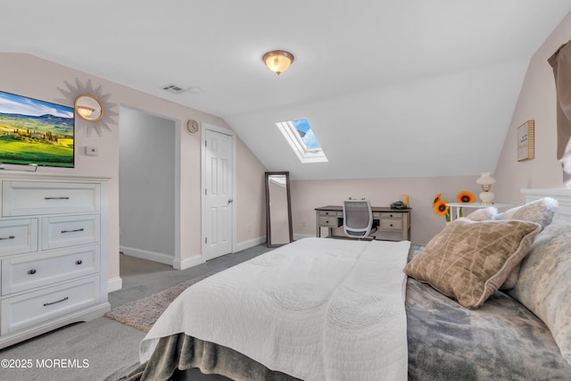 bedroom with lofted ceiling with skylight and carpet