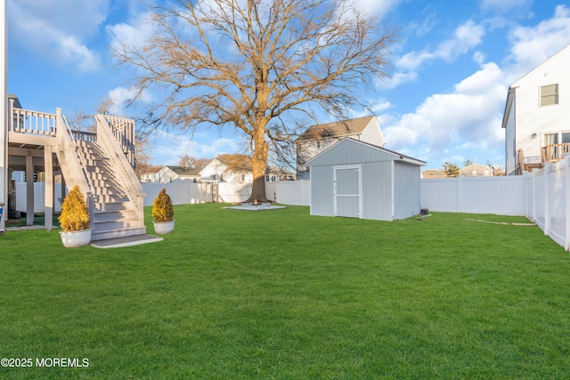 view of yard featuring a deck and a shed