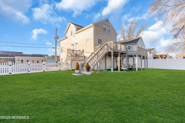 rear view of property featuring a deck and a yard