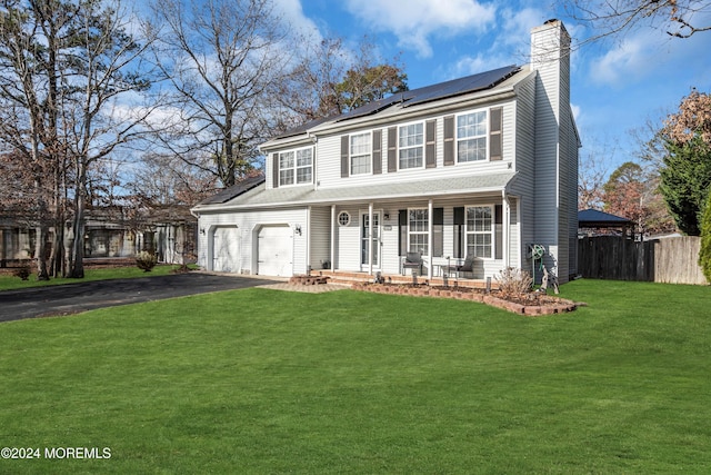 view of front facade with a front lawn, covered porch, and solar panels