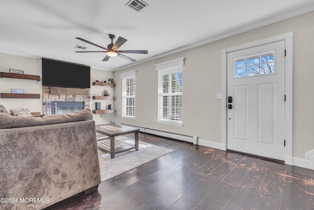 living room with a stone fireplace, ceiling fan, a baseboard radiator, and ornamental molding