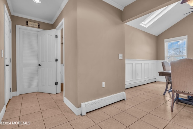 interior space featuring a skylight, ornamental molding, and a baseboard heating unit