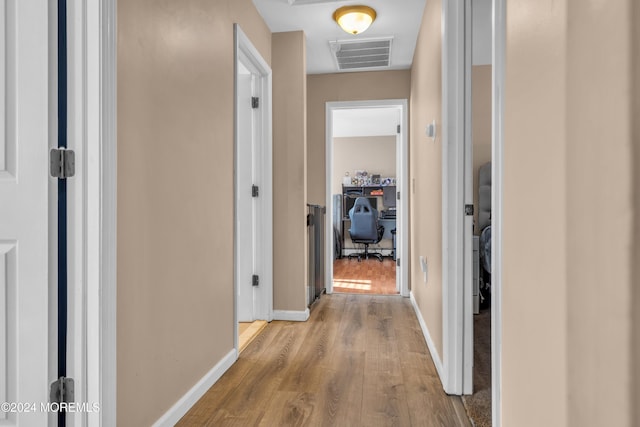 corridor with light hardwood / wood-style flooring