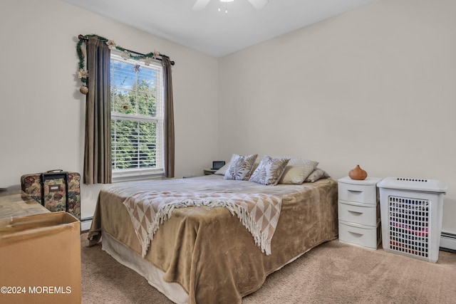 bedroom with ceiling fan, carpet floors, and a baseboard radiator