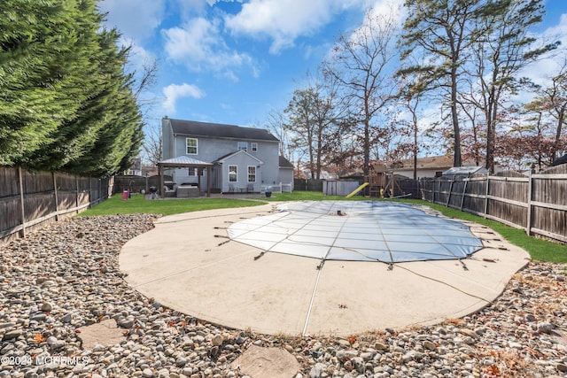 view of pool with a gazebo, a playground, a patio, and a yard