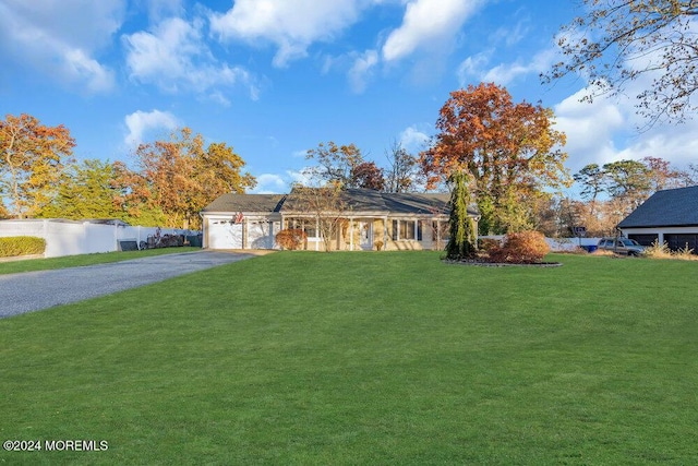 ranch-style house with a garage and a front yard