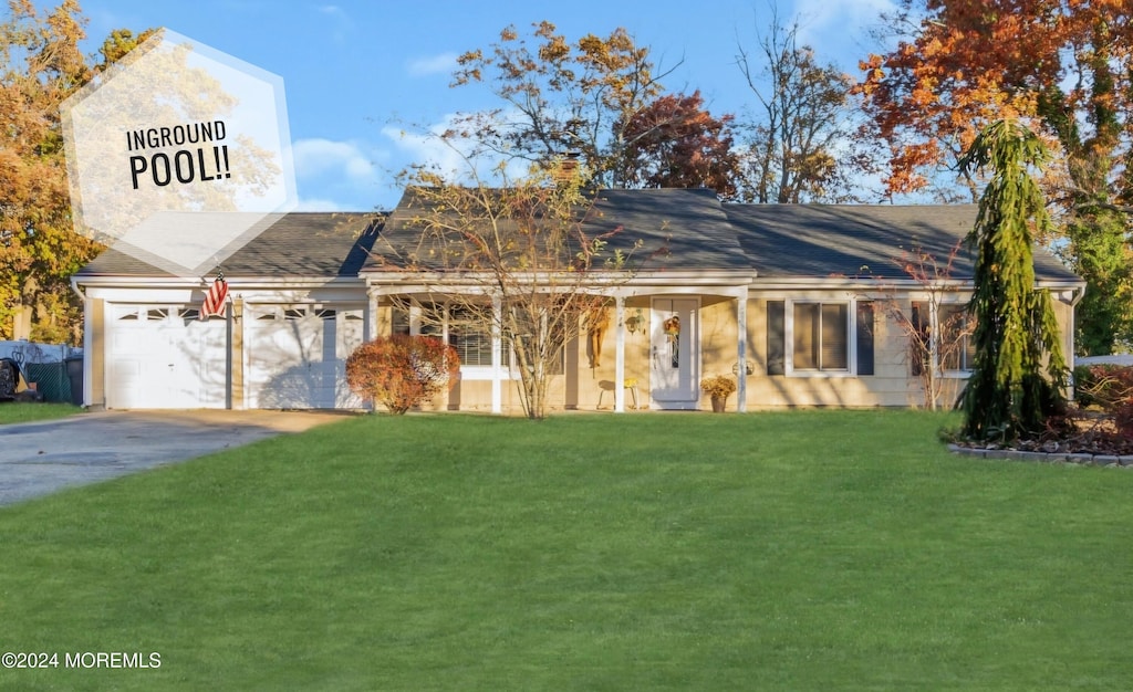 exterior space with a garage and a front lawn