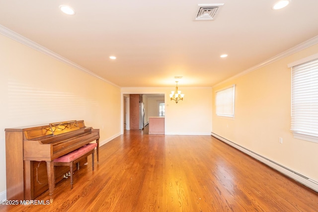 unfurnished room featuring baseboard heating, crown molding, hardwood / wood-style floors, and a notable chandelier