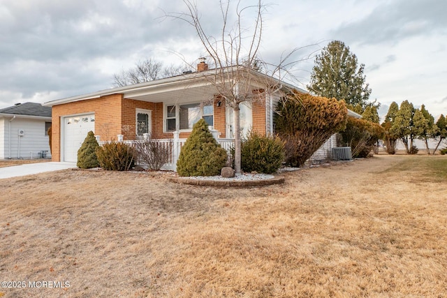 ranch-style home featuring a garage, a front yard, central AC, and covered porch