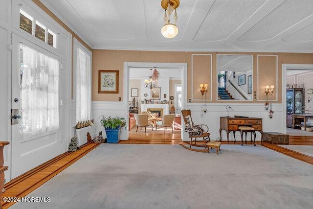 sitting room featuring carpet floors and ornamental molding