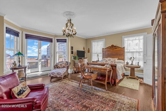 bedroom featuring an inviting chandelier, ornamental molding, dark wood-type flooring, and multiple windows